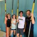 Four young vaulters with poles